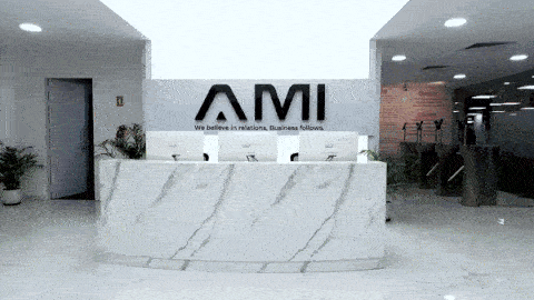 AM Infoweb reception area featuring the AMI logo wall, reflecting a professional workplace and trusted business operations environment.